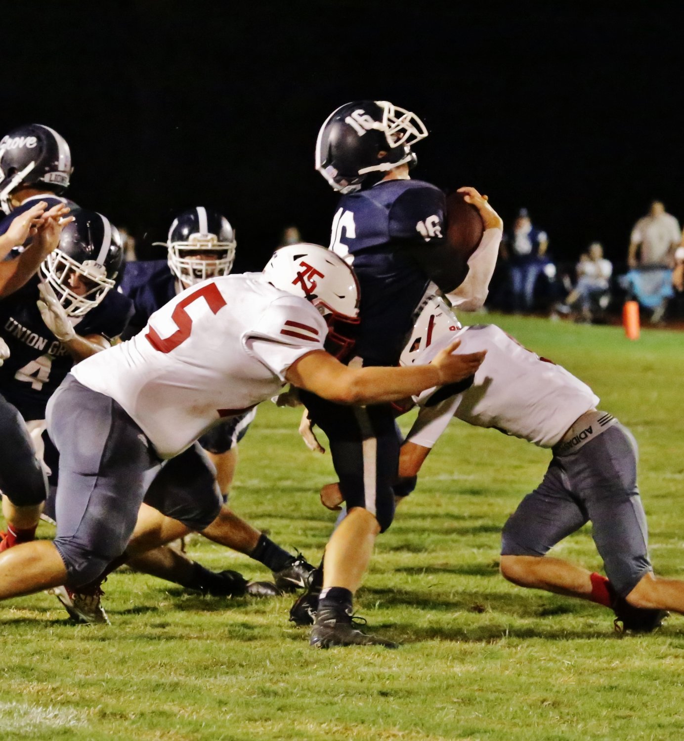 Alba-Golden’s Jayden Green (left) and Caleb Anderson crunch a Union Grove ball carrier. (Monitor photo by John Arbter)